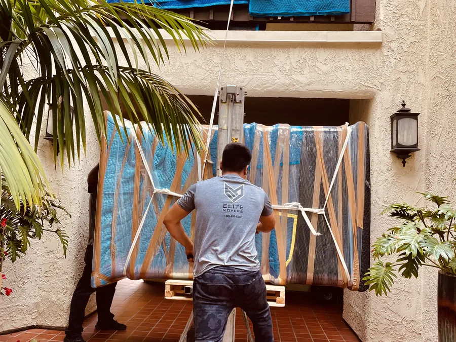 A padded piece on a hoist at a second-floor balcony