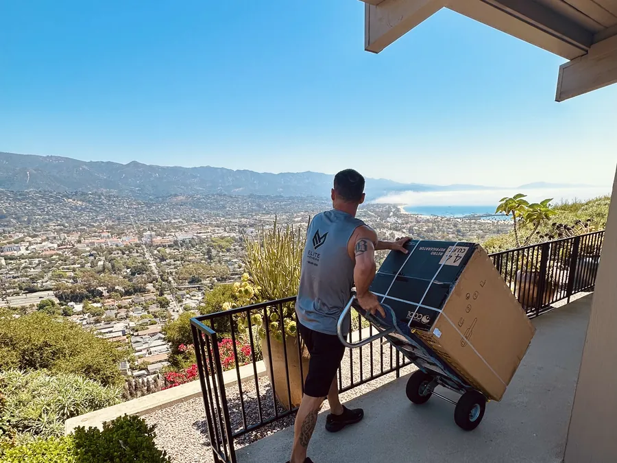 Hand-trucking boxes along a hillside terrace