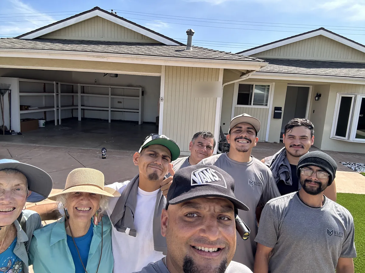 The customers with the Elite crew outside the house after the move