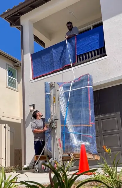 Grand piano lifted to a second-floor balcony
